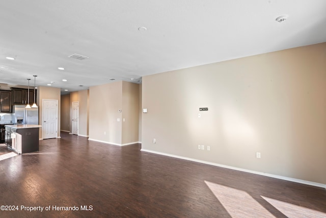 unfurnished living room featuring dark wood-type flooring