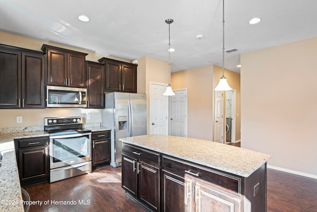 kitchen with dark brown cabinetry, stainless steel appliances, dark hardwood / wood-style floors, decorative light fixtures, and a kitchen island