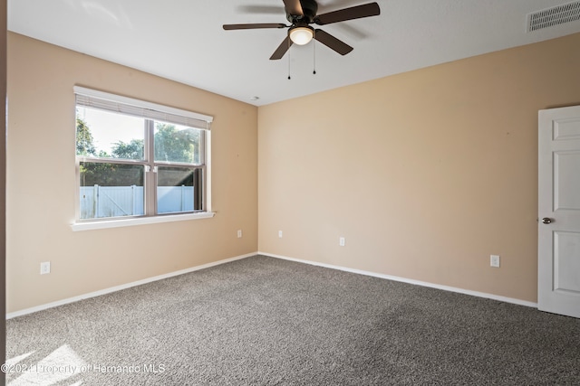 spare room featuring ceiling fan and carpet floors