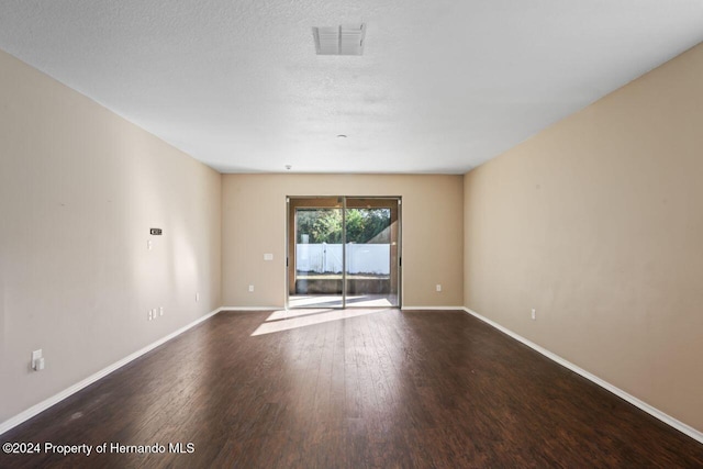 empty room featuring hardwood / wood-style floors and a textured ceiling