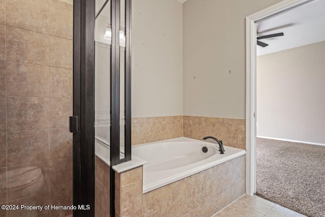 bathroom featuring tile patterned flooring, ceiling fan, and plus walk in shower