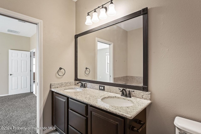 bathroom with vanity and toilet