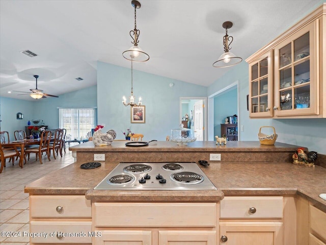 kitchen with pendant lighting, vaulted ceiling, stainless steel gas stovetop, light tile patterned flooring, and ceiling fan with notable chandelier