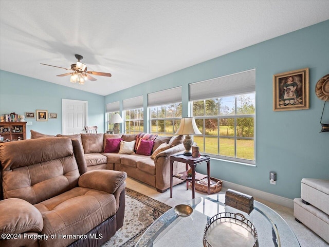 carpeted living room featuring vaulted ceiling and ceiling fan