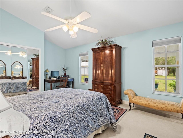 carpeted bedroom featuring multiple windows, a closet, ceiling fan, and lofted ceiling