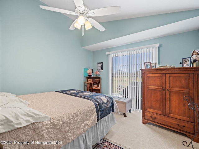 carpeted bedroom featuring ceiling fan and lofted ceiling