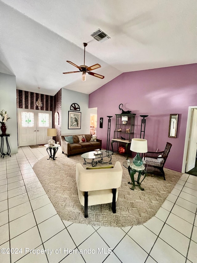 tiled living room with ceiling fan and vaulted ceiling