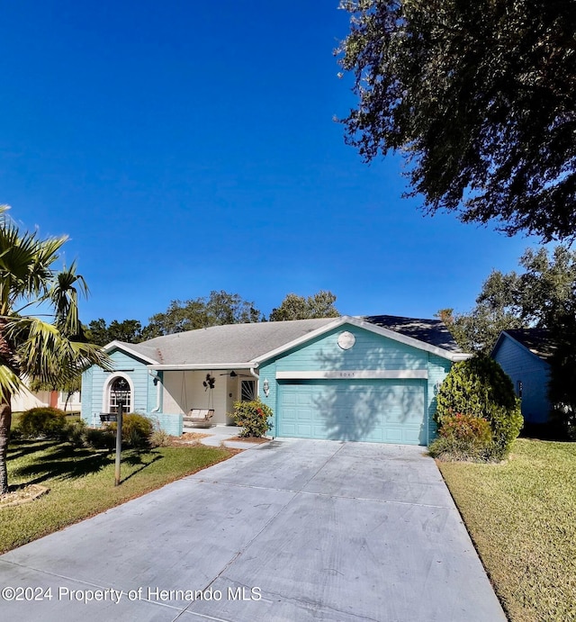 ranch-style house with a front yard and a garage