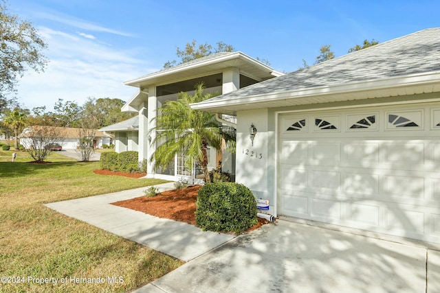 view of front of property with a front lawn and a garage