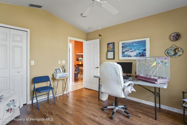 office area featuring ceiling fan, wood-type flooring, and lofted ceiling