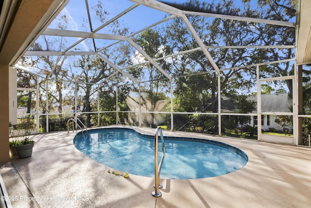 view of swimming pool featuring a patio and glass enclosure