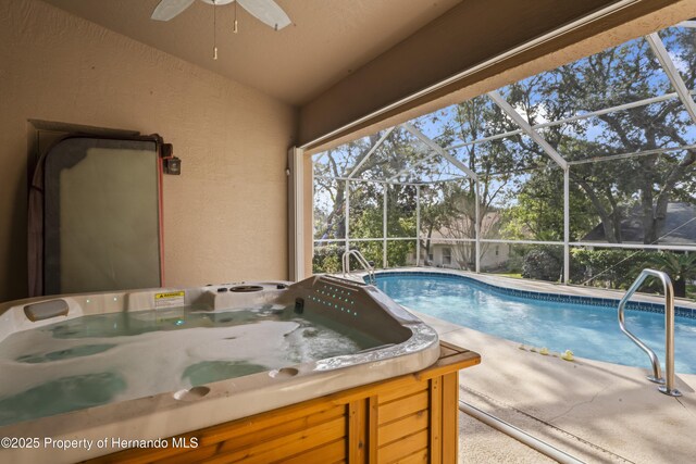 view of swimming pool featuring a hot tub