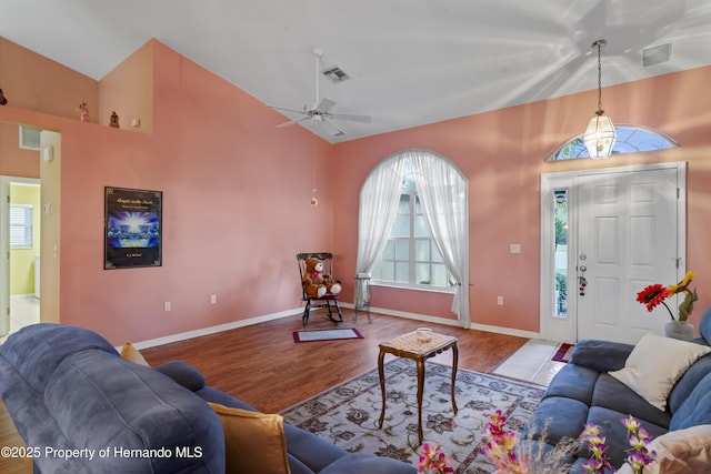 living room featuring light wood-type flooring, vaulted ceiling, and ceiling fan