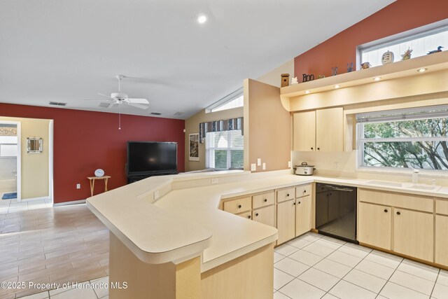 kitchen featuring kitchen peninsula, sink, light brown cabinets, and black dishwasher