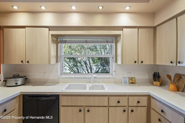 kitchen featuring backsplash, dishwasher, light brown cabinets, and sink