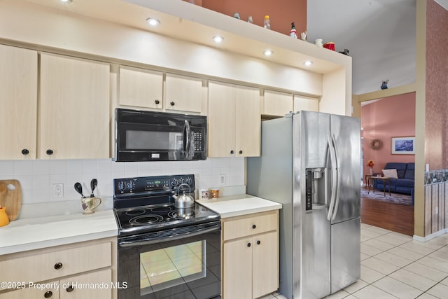 kitchen with tasteful backsplash, light brown cabinetry, light tile patterned floors, and black appliances