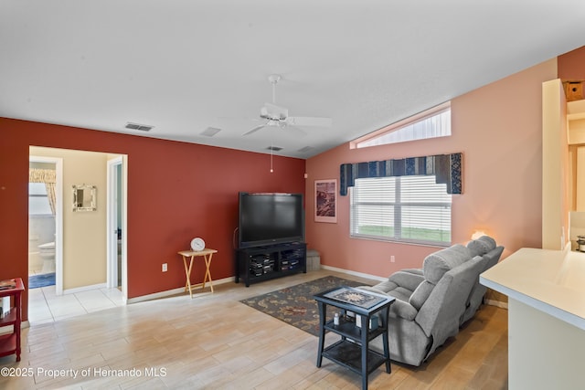 living room with vaulted ceiling, light hardwood / wood-style flooring, and ceiling fan