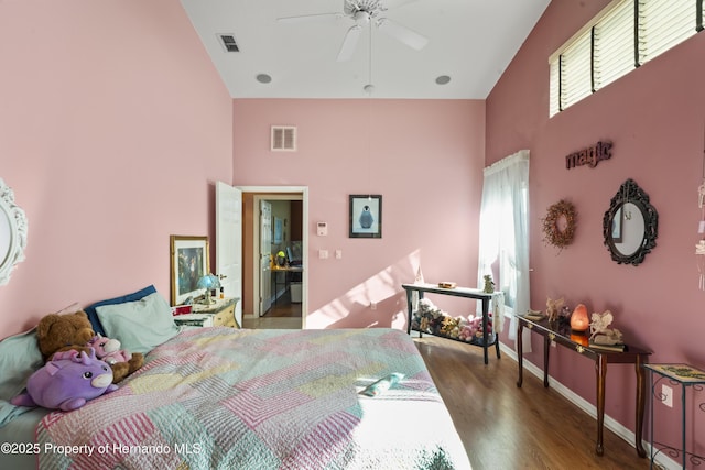 bedroom with multiple windows, high vaulted ceiling, ceiling fan, and dark wood-type flooring