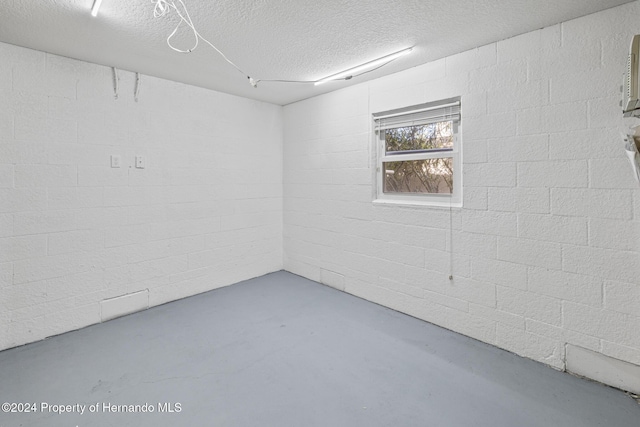 empty room with concrete flooring and a textured ceiling