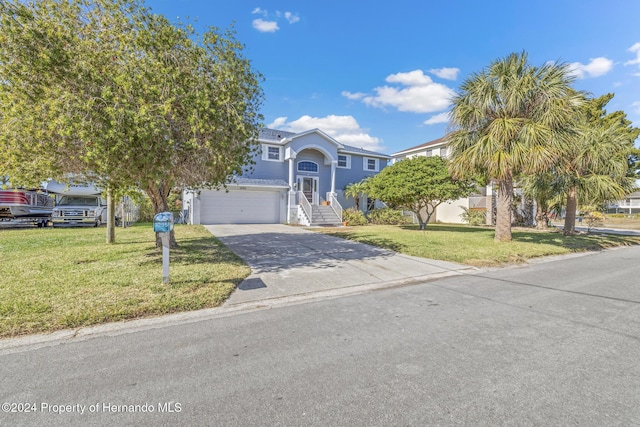 view of front of house with a garage and a front yard