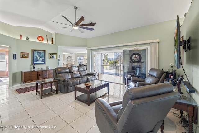 living room with light tile patterned floors, ceiling fan, and lofted ceiling