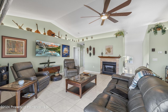 living room featuring ceiling fan, light tile patterned flooring, and lofted ceiling