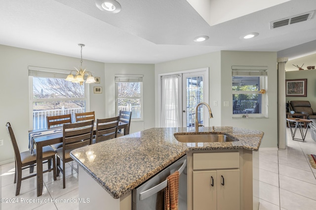 kitchen with dishwasher, an island with sink, a healthy amount of sunlight, and sink