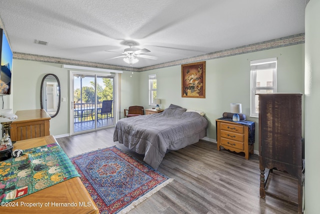 bedroom with hardwood / wood-style flooring, ceiling fan, a textured ceiling, and access to outside