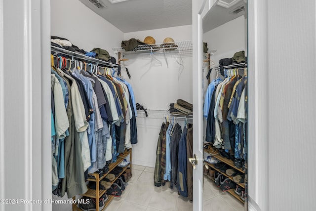 spacious closet with light tile patterned floors