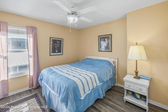 bedroom with dark hardwood / wood-style flooring, multiple windows, and ceiling fan