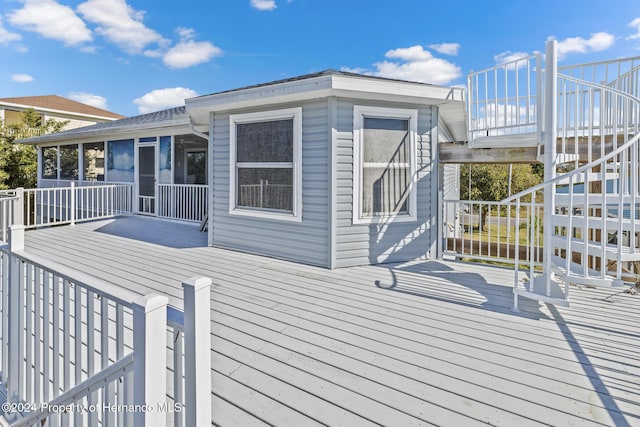 wooden terrace featuring a sunroom