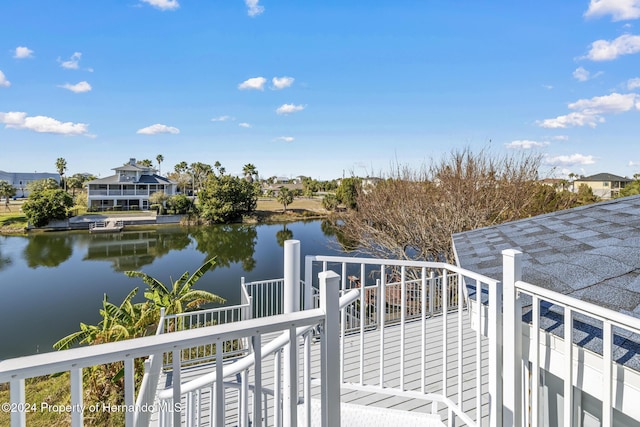 balcony with a residential view and a water view