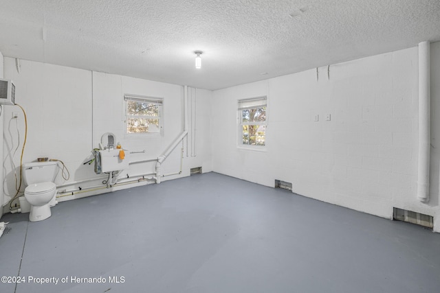 basement featuring a textured ceiling