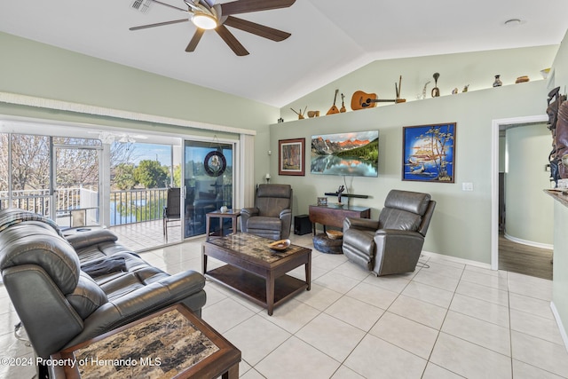 living room with light tile patterned floors, ceiling fan, and lofted ceiling