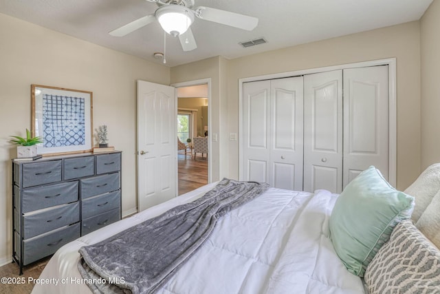 bedroom featuring visible vents, ceiling fan, a closet, and baseboards