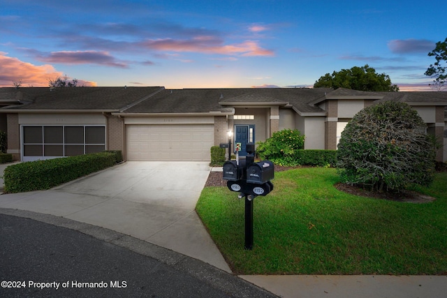 view of front of property with a yard and a garage