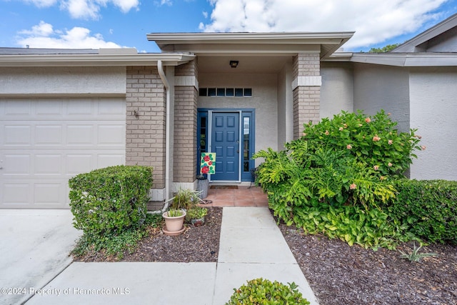 view of exterior entry with a garage