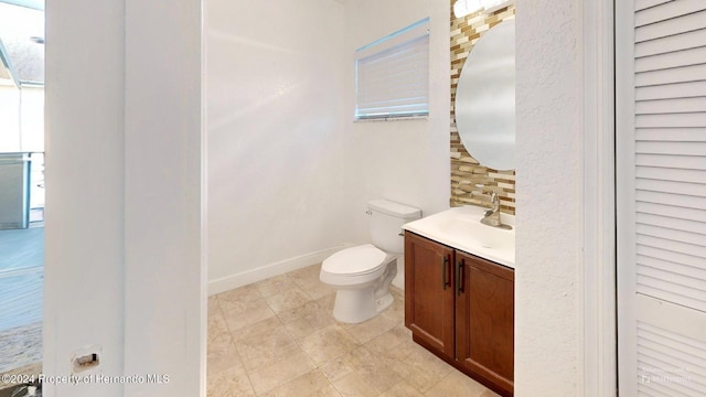 bathroom with decorative backsplash, vanity, and toilet