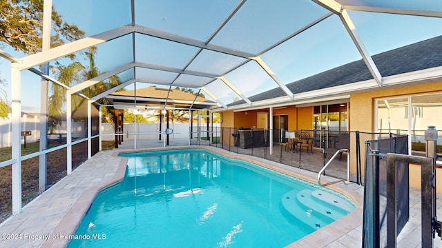 view of swimming pool featuring a patio area and a lanai