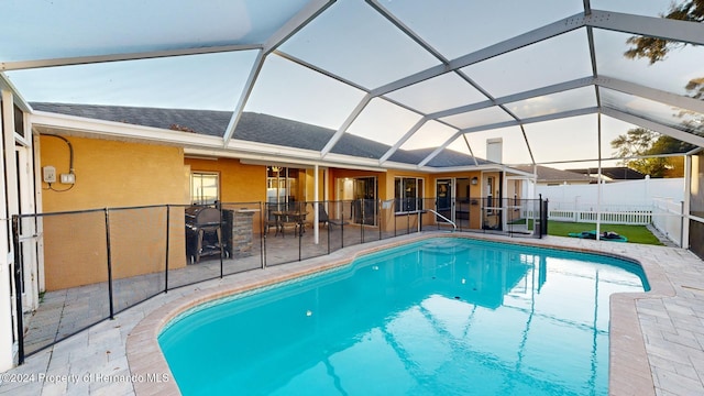 view of pool featuring a lanai and a patio