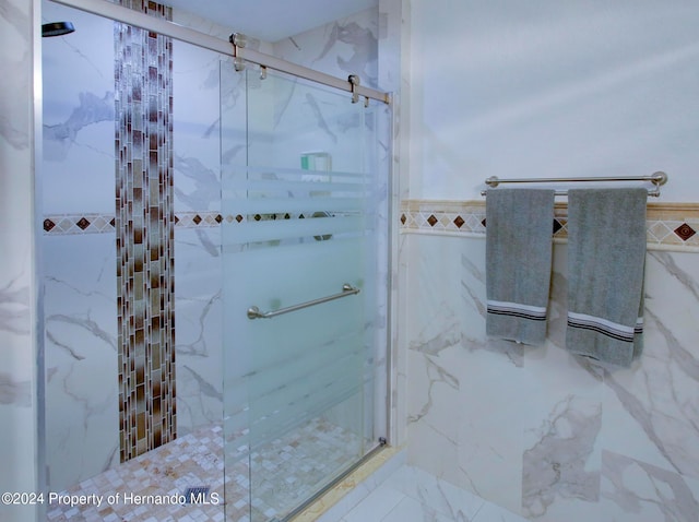 bathroom featuring walk in shower and tile walls