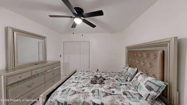 bedroom with ceiling fan and a textured ceiling