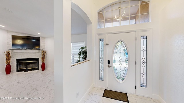 foyer featuring a large fireplace