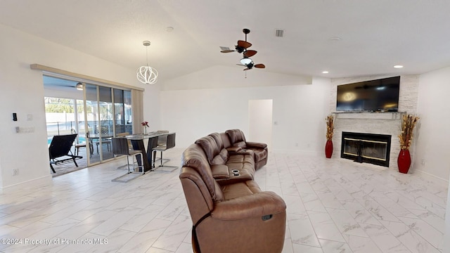 living room with a fireplace, vaulted ceiling, and ceiling fan