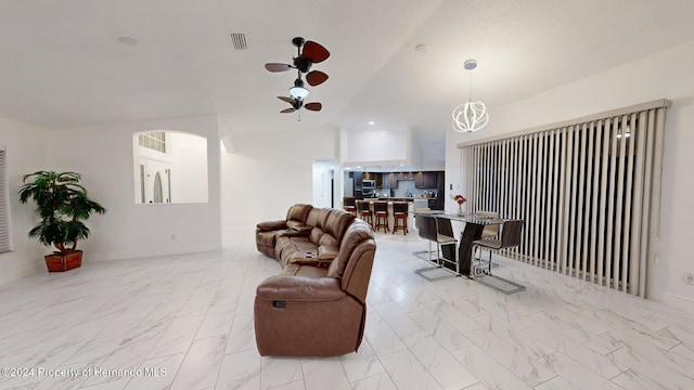 living room featuring ceiling fan and lofted ceiling