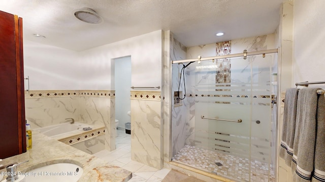 full bathroom featuring plus walk in shower, a textured ceiling, vanity, and toilet