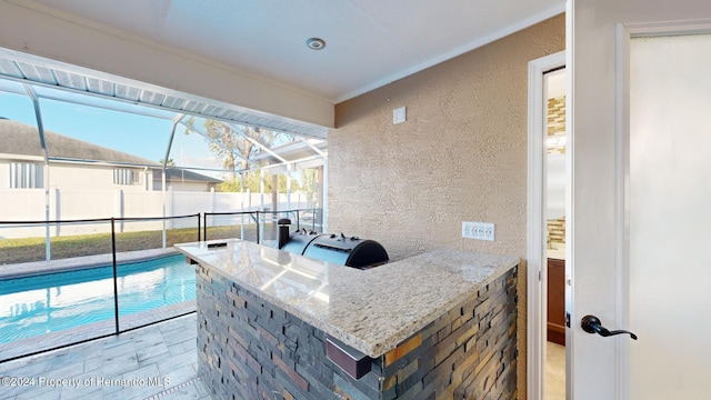 view of swimming pool with a lanai and an outdoor bar