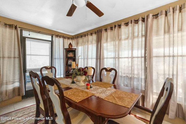 tiled dining space featuring ceiling fan