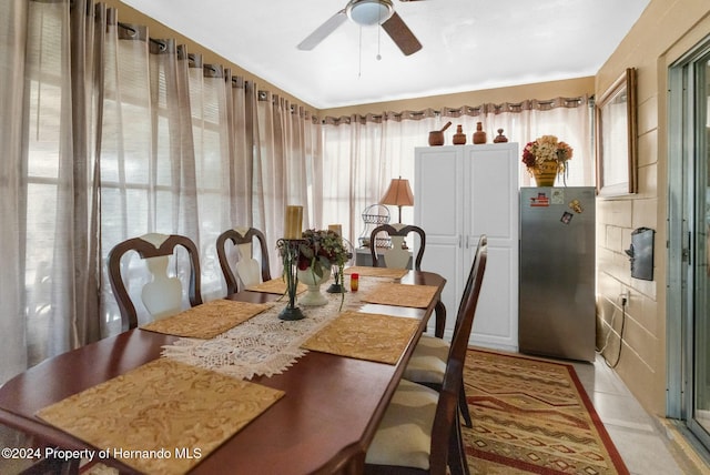 dining space with light tile patterned floors and ceiling fan