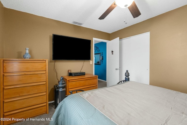 bedroom featuring ceiling fan, carpet floors, and a closet